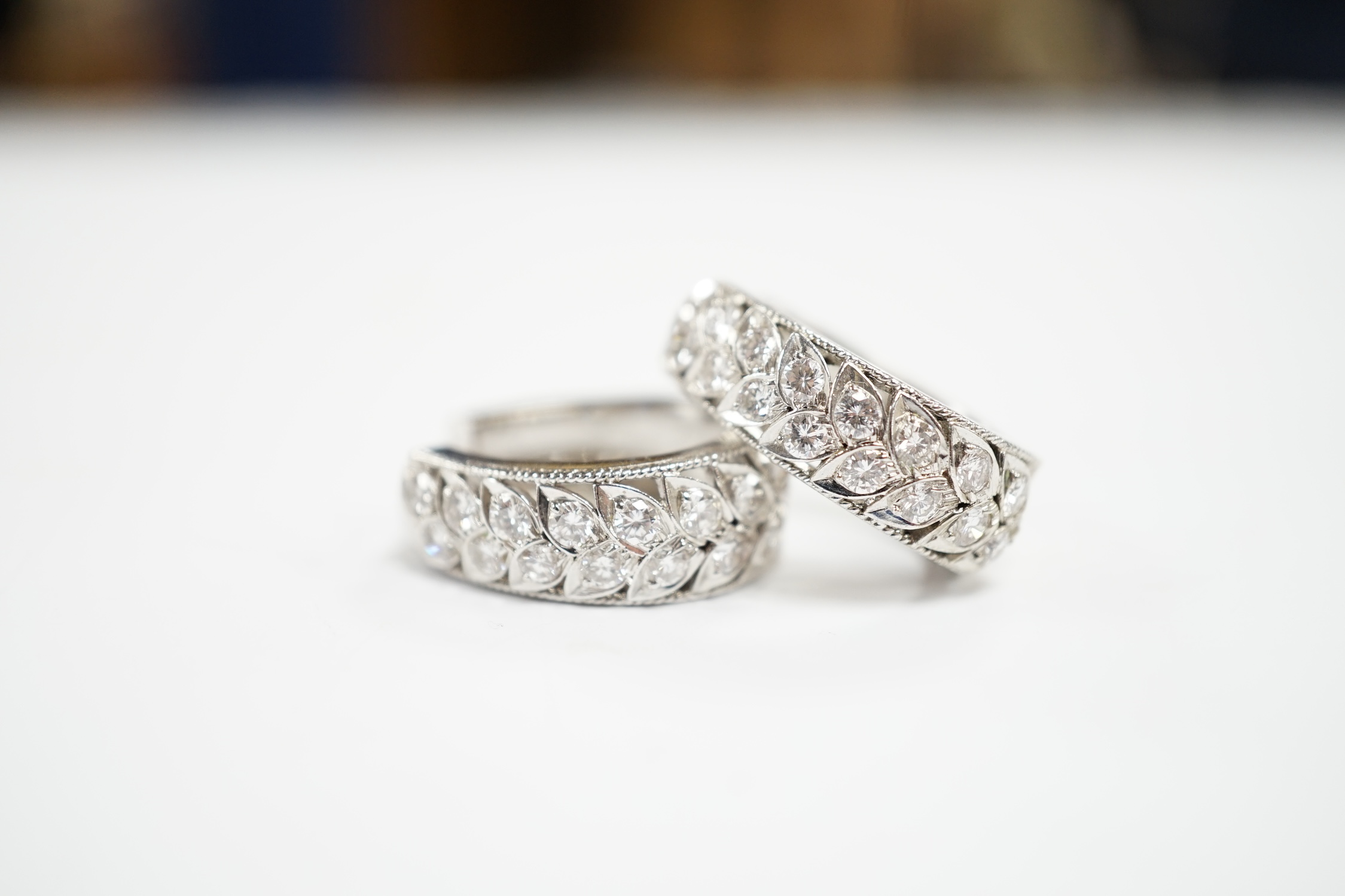 A modern pair of white metal and diamond cluster set half hoop earrings, 20mm, gross weight 8.9 grams.